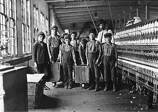 Historical photograph of young mill workers and superintendent inside a North Carolina cotton mill.