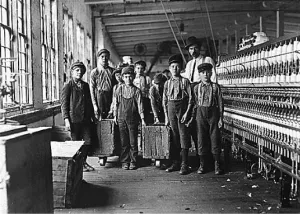Historical photograph of young mill workers and superintendent inside a North Carolina cotton mill.